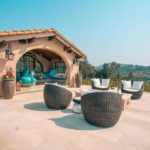 Outdoor sitting area next two a pool house with two black Sonance Mariners