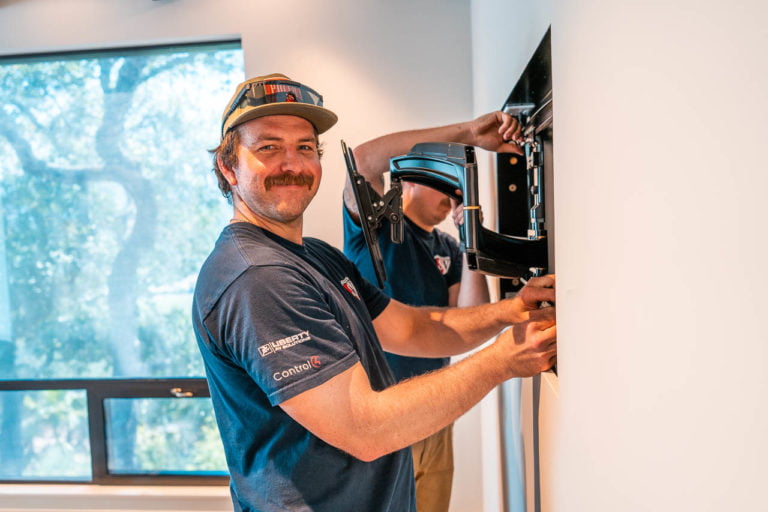 happy-technician-hanging-tv-mount