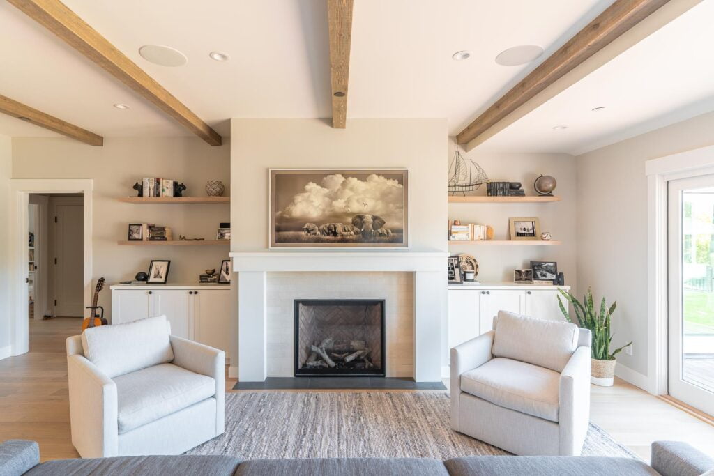 65" Samsung Frame TV above the fireplace displaying artwork. Viewed from the perspective on the couch.